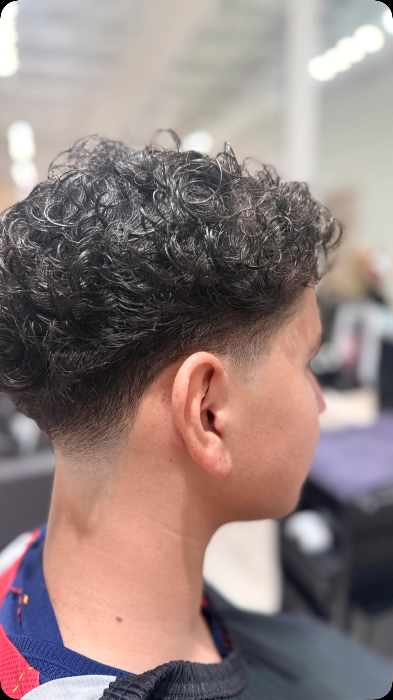 Curly top with a low taper fade