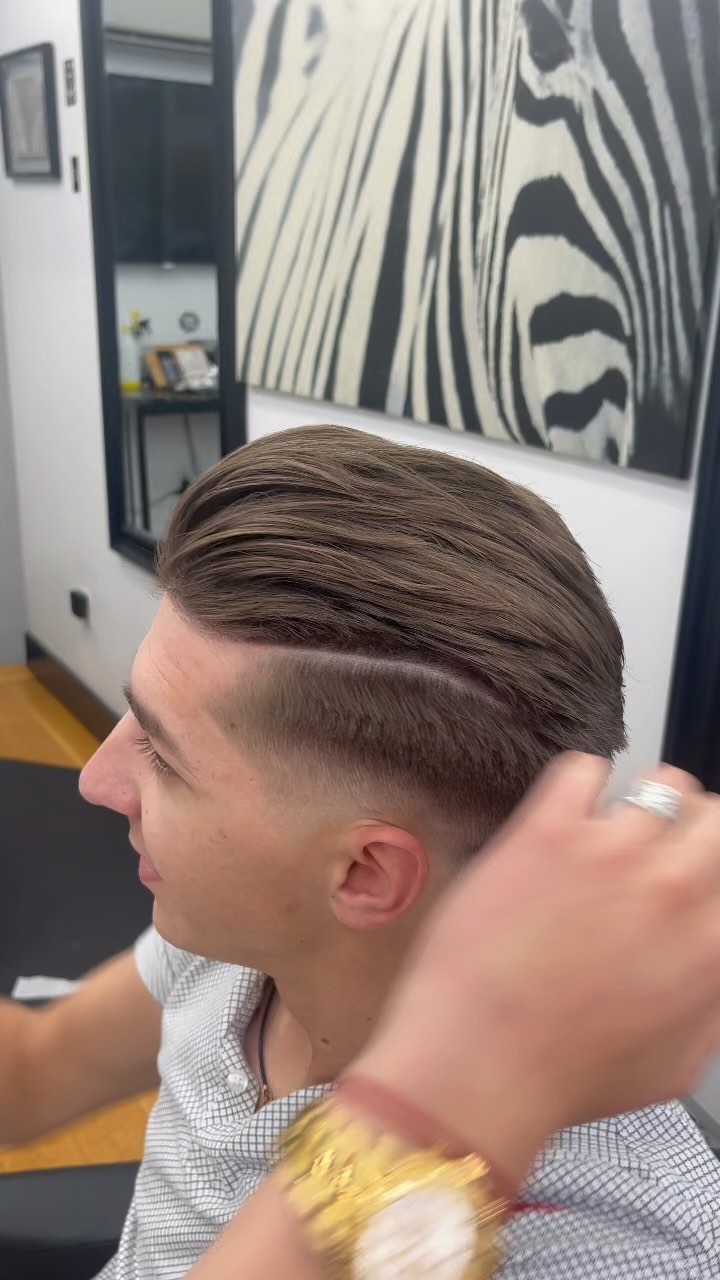 Pompadour with a hard part and skin fade